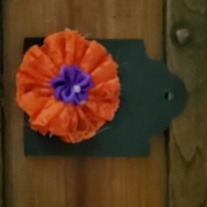 Orange and purple hair accessorie.